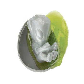 Green and gray toy figure of an alien on a white background